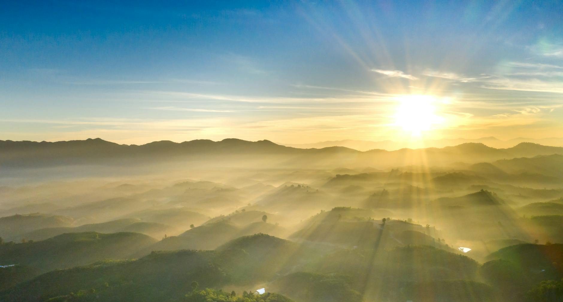 sunlight over hills at sunset