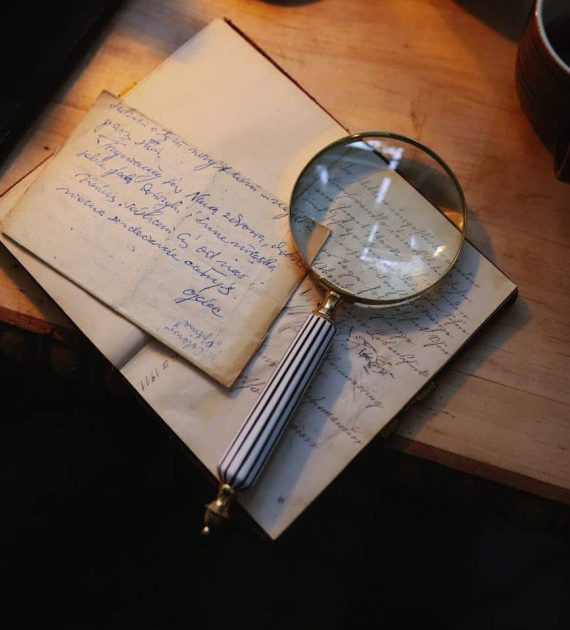 photo of a magnifying glass on top of a notebook with text